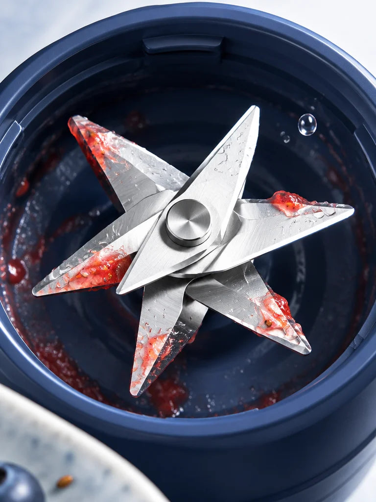 A tight macro photograph looking into the blade end of the exact portable blender, using the product